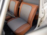two seats in the back of a car with a brown seat cover