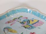 a blue and white bowl with a picture of a bird on it