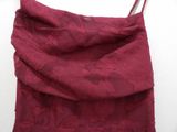 a close up of a red dress on a white surface