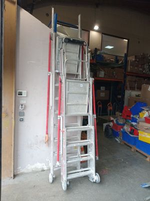 a ladder that is sitting in a garage next to a pile of boxes