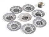 nine plates and a cup sitting on a table