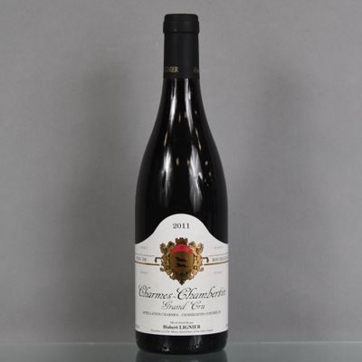 a bottle of wine sitting on a glass table