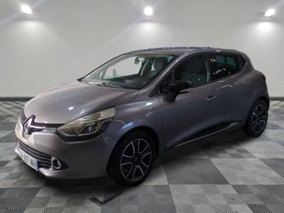 the grey car is parked on a checkered tile floor