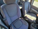 two seats in the back of a van with a cup holder