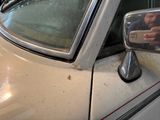 a man taking a picture of himself in the mirror of a car