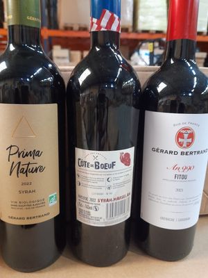 trois bouteilles de vin posées les unes à côté des autres sur un comptoir