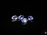 three blue sapphires on a black background