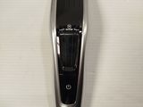 a silver and black hair clipper on a white table