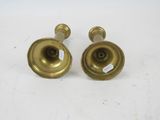 pair of antique brass candlesticks on a white background