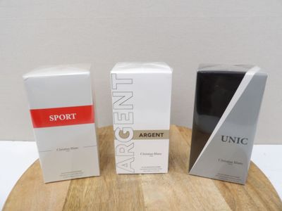 three boxes of perfume sitting on top of a wooden table next to each other