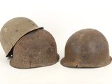 two helmets are sitting next to each other on a white surface