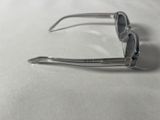 sunglasses on a table with a white table cloth and a pair of scissors