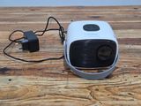 a small projector sitting on top of a wooden table