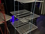 a metal shelf with three shelves on top of it