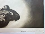 a black and white photo of a man laying on the ground