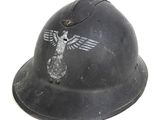 an old helmet with a bird on it sitting on a white surface