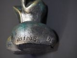 a close up of a statue of a person on a bell