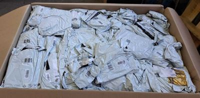 a cardboard box full of white shirts on a table