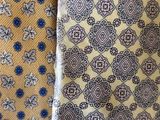 three different colored ties hanging on a wall next to each other