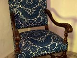a blue and white chair in the corner of a room