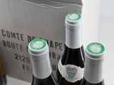 three bottles of wine that are sitting in a box