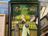 a picture of a picture of a woman and a cow on display