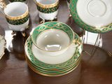 a table that has a lot of tea cups and saucers on it