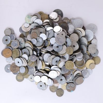 a pile of old coins on a white surface