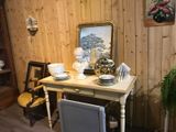 a small table with a mirror on top of it in a room