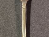 a silver fork with two forks sticking out of it