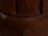 a close up of a wooden vase with a bird on it
