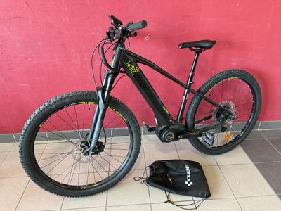 a bike that is sitting on the floor next to a bag