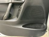a close up of a car door with a speaker in it