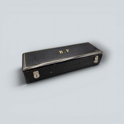 a small black box with a gold initials on it