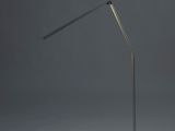 a black floor lamp with a black base and a white light bulb