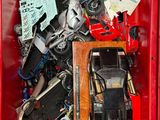 a red box filled with assorted toy cars