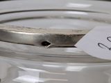 a glass jar with a label on it with a sticker on it