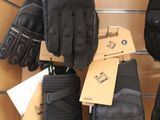 many pairs of gloves hanging on a wall in a store