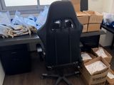 a desk with a chair and boxes of boxes on it