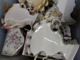 a box full of tea cups and saucers and a teddy bear