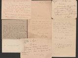 several old letters and envelopes on a table with a black background