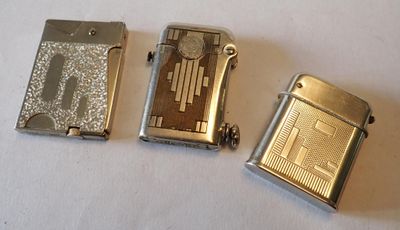 trois briquets posés les uns à côté des autres sur une table