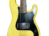 an electric bass guitar with a yellow body on a white background