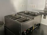 an image of a commercial kitchen with three deep fryers