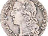 gros plan d'une pièce de monnaie sur laquelle figure un visage de femme