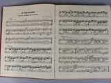 an open book with music notes on it