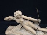statue of a woman with a bow and arrow on a black background