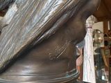 a bronze statue of a woman with long hair
