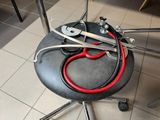 a red stethoscope on a black chair with a red cord