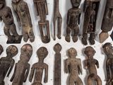 a lot of wooden figurines that are on a table